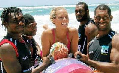 Carried awat: Courtney Hancock gets a ride across the sand from the visiting PNG rugby squad. Carried awat: Courtney Hancock gets a ride across the sand from the visiting PNG rugby squad.